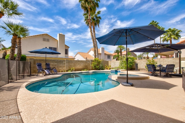 view of pool featuring a fenced backyard, a patio area, and a pool with connected hot tub