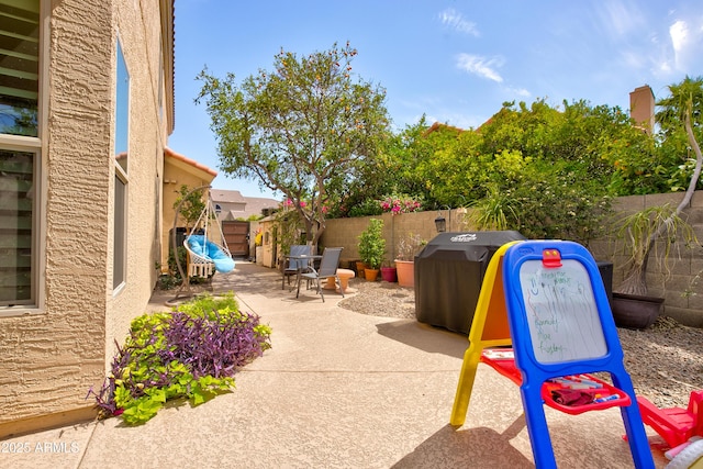 view of patio with a fenced backyard and a grill