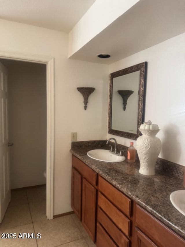 full bathroom featuring a sink, tile patterned floors, and double vanity
