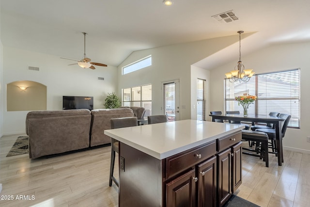 kitchen featuring light countertops, visible vents, decorative light fixtures, and light wood finished floors