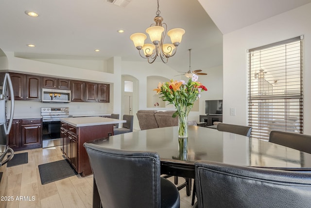 dining room with vaulted ceiling, light wood finished floors, visible vents, and recessed lighting