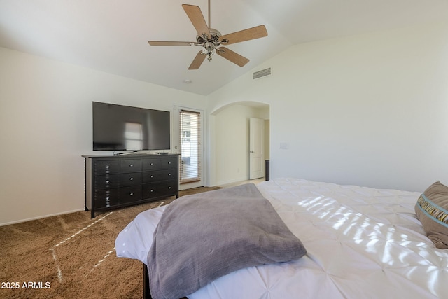 carpeted bedroom featuring lofted ceiling, visible vents, arched walkways, and a ceiling fan