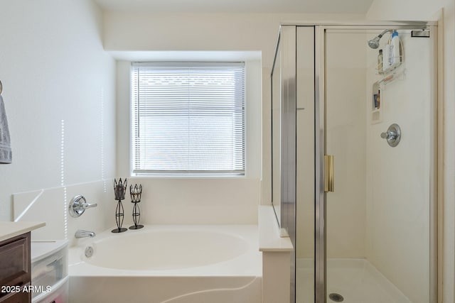 full bathroom featuring a stall shower, vanity, and a bath