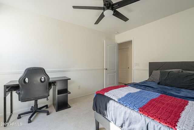 carpeted bedroom with ceiling fan and baseboards