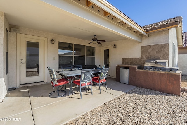 view of patio featuring outdoor dining area, ceiling fan, and area for grilling