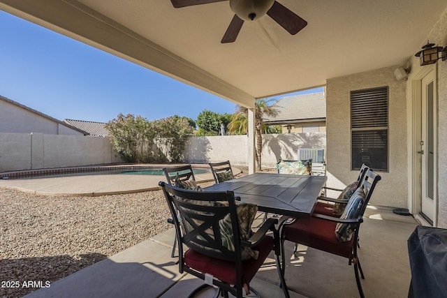 view of patio / terrace with a fenced in pool, outdoor dining area, a fenced backyard, and ceiling fan