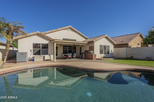 back of property with a fenced in pool, a patio, stucco siding, central air condition unit, and fence