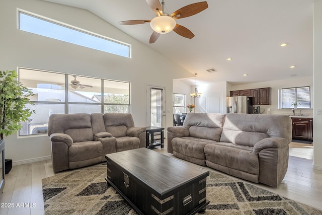 living area with ceiling fan, high vaulted ceiling, light wood-style flooring, recessed lighting, and visible vents