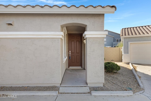 view of exterior entry featuring a garage