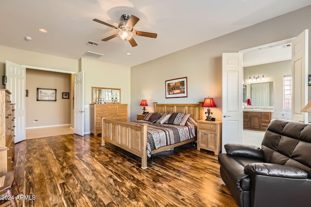 bedroom featuring ceiling fan, dark hardwood / wood-style flooring, ensuite bathroom, and sink