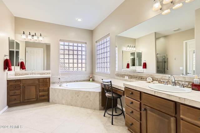 bathroom featuring tile patterned flooring, vanity, and shower with separate bathtub