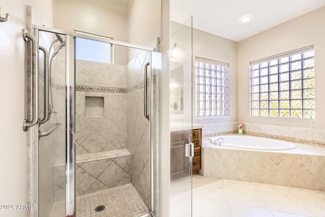 bathroom with tile patterned floors, plus walk in shower, and vanity