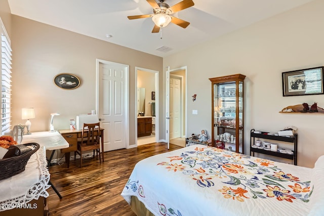 bedroom with ensuite bath, ceiling fan, and dark hardwood / wood-style flooring