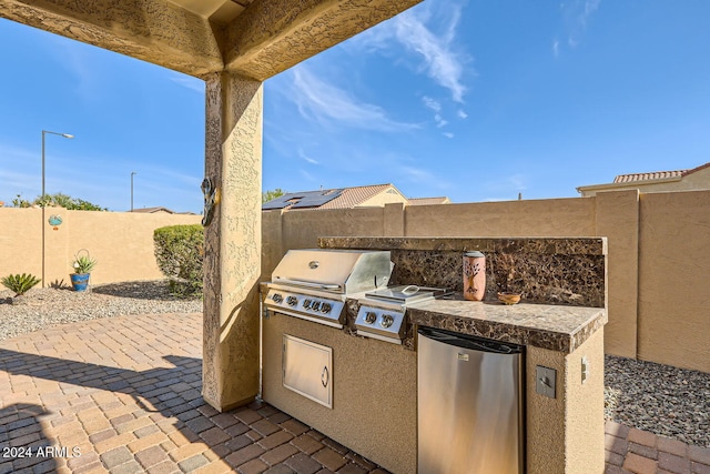 view of patio / terrace with grilling area and an outdoor kitchen