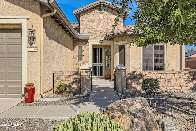 view of exterior entry with a garage