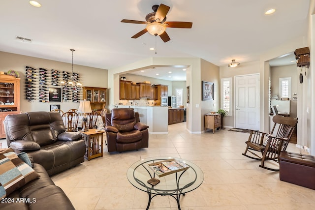 tiled living room featuring ceiling fan and plenty of natural light