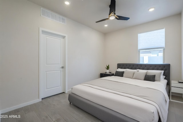 bedroom with baseboards, visible vents, a ceiling fan, light wood-type flooring, and recessed lighting