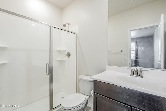 bathroom featuring a shower stall, toilet, and vanity