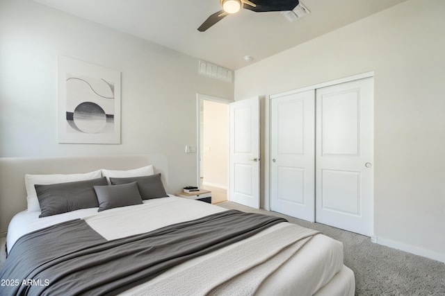 carpeted bedroom featuring baseboards, visible vents, ceiling fan, and a closet