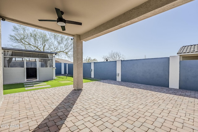 view of patio / terrace featuring a ceiling fan and fence