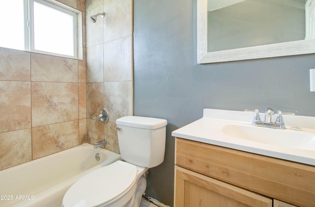 full bathroom with vanity, toilet, and tiled shower / bath