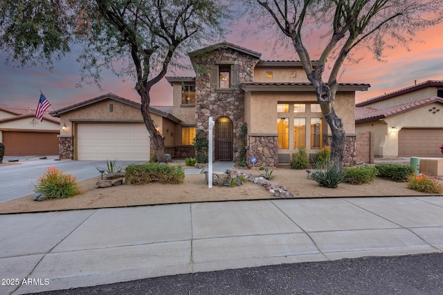 mediterranean / spanish home featuring a garage