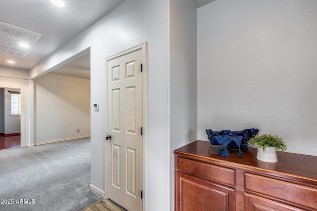 hallway featuring light carpet