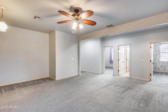 carpeted spare room with ceiling fan