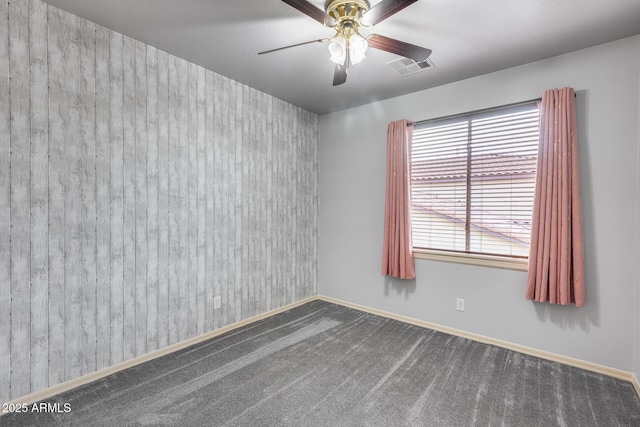 carpeted spare room with ceiling fan