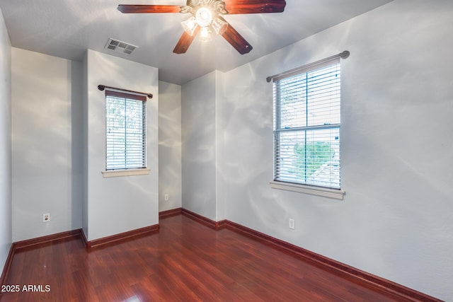 unfurnished room with dark wood-type flooring and ceiling fan