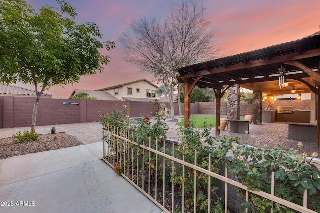 patio terrace at dusk with an outdoor kitchen