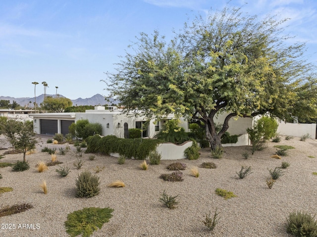 view of front facade with a garage and a mountain view