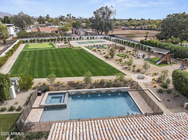 view of swimming pool with an in ground hot tub and a lawn