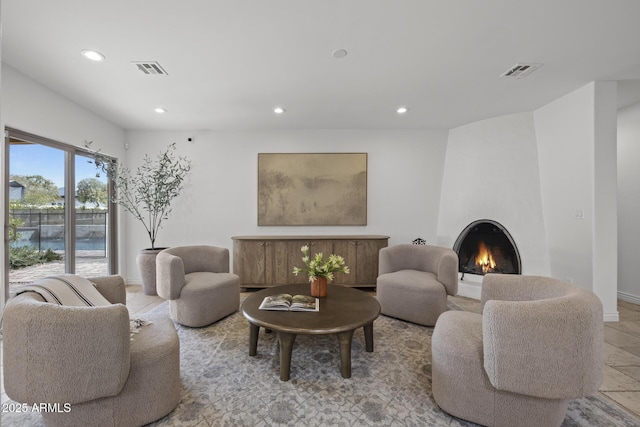 living room featuring a large fireplace