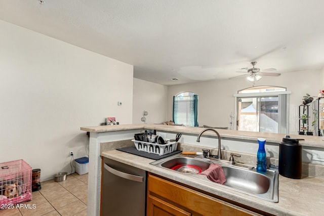 kitchen with sink, stainless steel dishwasher, ceiling fan, and light tile patterned floors