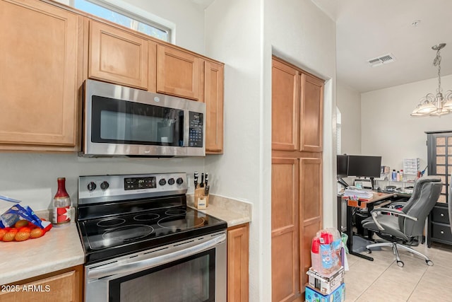 kitchen featuring an inviting chandelier, hanging light fixtures, light tile patterned floors, and stainless steel appliances