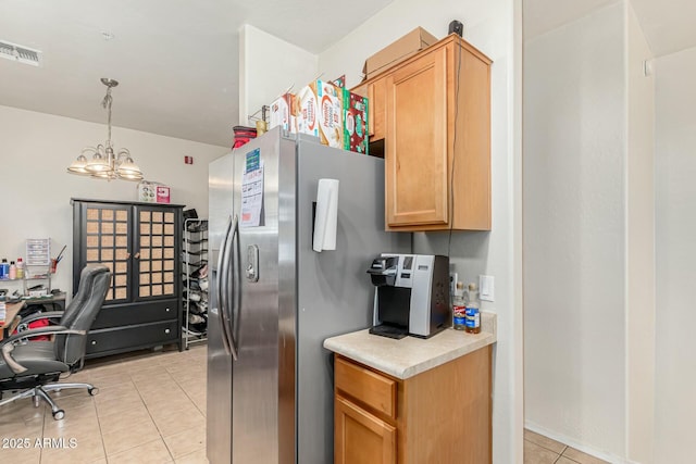 kitchen featuring stainless steel refrigerator with ice dispenser, decorative light fixtures, light tile patterned flooring, and a chandelier