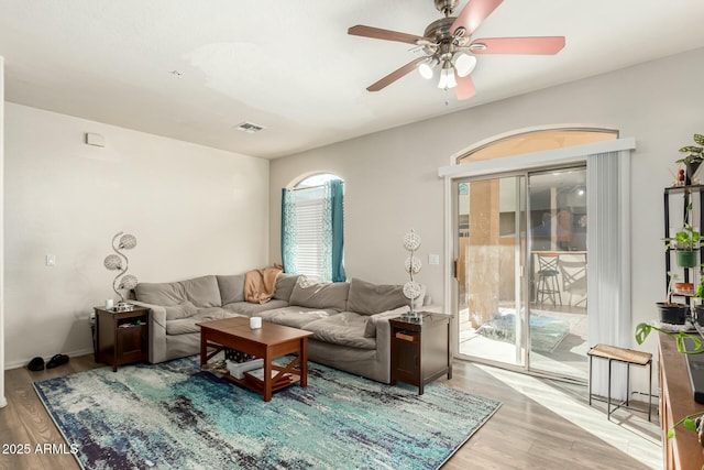 living room featuring light hardwood / wood-style flooring and ceiling fan