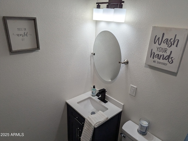 bathroom featuring toilet and vanity