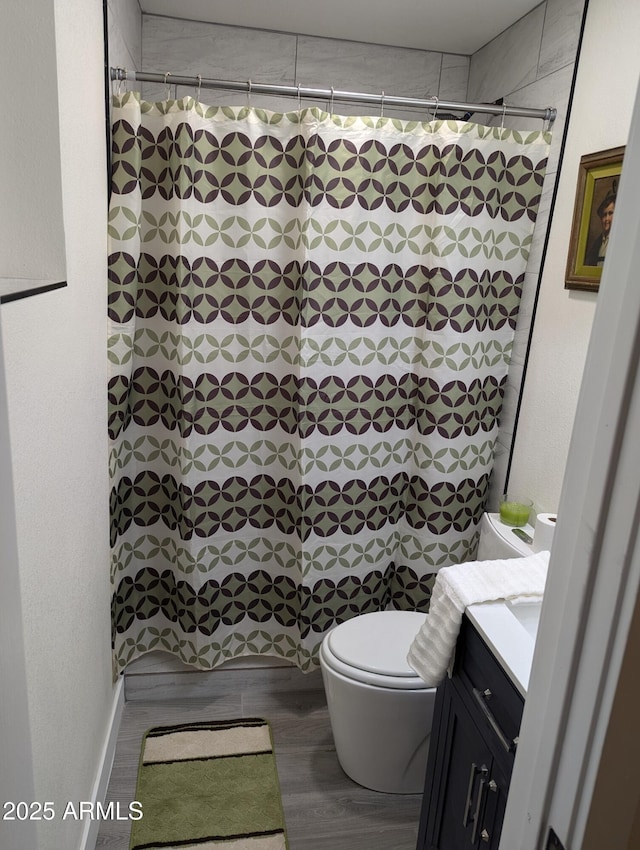 bathroom with hardwood / wood-style flooring, toilet, and vanity