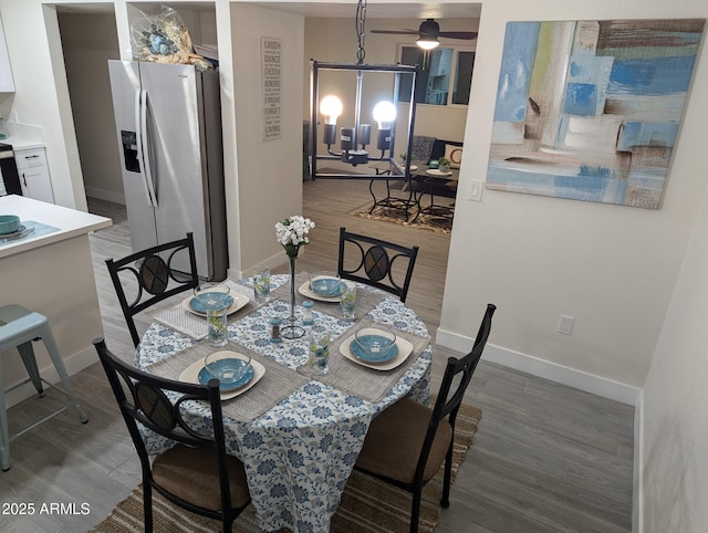 dining room featuring dark hardwood / wood-style flooring and an inviting chandelier