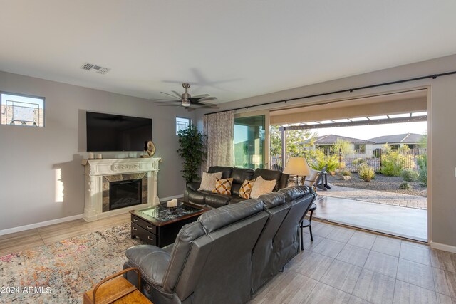 living area featuring light hardwood / wood-style flooring and ceiling fan