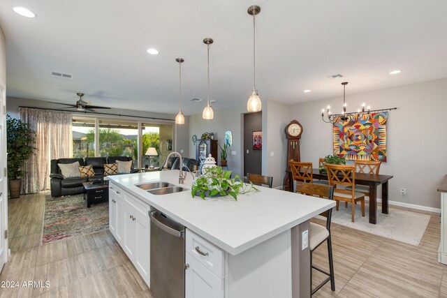 living room featuring ceiling fan, a tiled fireplace, and light hardwood / wood-style floors