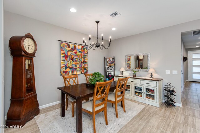 living room featuring ceiling fan with notable chandelier, light hardwood / wood-style flooring, and sink