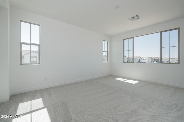 empty room featuring light colored carpet