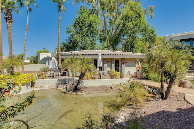 back of property with a patio, fence, a tile roof, and stucco siding