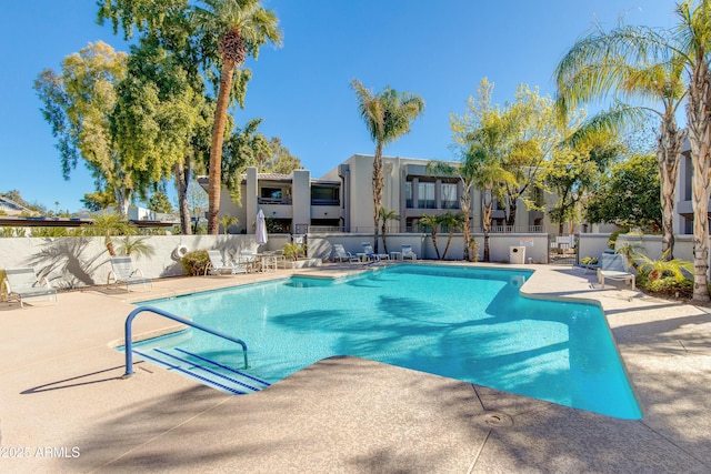 pool featuring a patio area and fence