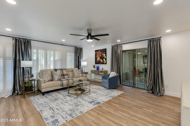 living area featuring recessed lighting, baseboards, a ceiling fan, and wood finished floors