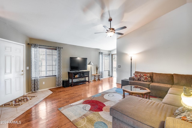 living room featuring ceiling fan, vaulted ceiling, and hardwood / wood-style flooring