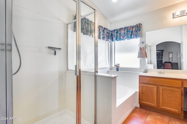 bathroom with plus walk in shower, tile floors, and large vanity